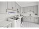 Bright laundry room with modern gray cabinets and patterned floor at 20684 E Natalie Way, Queen Creek, AZ 85142