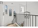 Elegant staircase with metal railing and light-filled landing at 20684 E Natalie Way, Queen Creek, AZ 85142