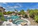 Inviting backyard with a sparkling pool, hot tub, and lush landscaping at 22830 N 32Nd Ln, Phoenix, AZ 85027