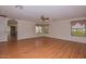 Spacious bedroom with wood flooring, ceiling fan, and multiple windows at 22830 N 32Nd Ln, Phoenix, AZ 85027