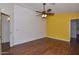 Bedroom with wood floors, ceiling fan, and accent wall at 22830 N 32Nd Ln, Phoenix, AZ 85027