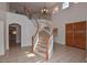 Elegant entryway with a curved staircase and chandelier at 22830 N 32Nd Ln, Phoenix, AZ 85027