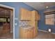 Bright laundry room with light wood cabinets and tile countertops at 22830 N 32Nd Ln, Phoenix, AZ 85027