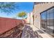 Landscaped backyard with a stucco wall and sliding glass door at 23570 N 75Th N St, Scottsdale, AZ 85255