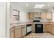 Efficient kitchen featuring wood cabinets and black appliances at 23570 N 75Th N St, Scottsdale, AZ 85255