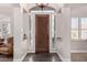 Elegant entryway with a wooden door and tile flooring at 24029 N 76Th Pl, Scottsdale, AZ 85255