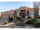 Tan two-story home with a two-car garage and stone accents at 24029 N 76Th Pl, Scottsdale, AZ 85255