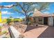 Landscaped backyard with brick patio, shade sail, and mature tree at 2434 E Pinchot Ave, Phoenix, AZ 85016