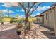 Landscaped backyard with brick patio, shade sail, and mature tree at 2434 E Pinchot Ave, Phoenix, AZ 85016