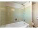 Clean bathroom with light green tile and a shower/tub combo at 2434 E Pinchot Ave, Phoenix, AZ 85016