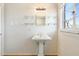 Simple bathroom with pedestal sink and glass shelves at 2434 E Pinchot Ave, Phoenix, AZ 85016