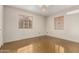 Bright bedroom with two windows, polished concrete floors, and a chandelier at 2434 E Pinchot Ave, Phoenix, AZ 85016