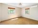 Spacious bedroom with two windows and terracotta flooring at 2434 E Pinchot Ave, Phoenix, AZ 85016