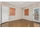 Bedroom with two windows, polished concrete floors, and exterior access at 2434 E Pinchot Ave, Phoenix, AZ 85016