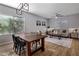 Bright dining area with wood table and chairs, hardwood floors, and natural light at 27121 N 84Th Dr, Peoria, AZ 85383