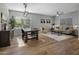 Bright dining area with wood table and chairs, hardwood floors, and natural light at 27121 N 84Th Dr, Peoria, AZ 85383