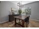 Elegant dining area with dark wood table and chairs, hardwood floors, and a chandelier at 27121 N 84Th Dr, Peoria, AZ 85383