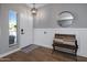 Entryway with white door, wood bench, and round mirror at 27121 N 84Th Dr, Peoria, AZ 85383