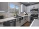 Modern kitchen with farmhouse sink, white cabinets, and stainless steel appliances at 27121 N 84Th Dr, Peoria, AZ 85383