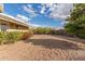 Large backyard with gravel, desert landscaping, and a fruit tree at 313 W Saddle Mountain Rd, Phoenix, AZ 85086