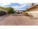 Gravel backyard with mature trees and a house exterior at 313 W Saddle Mountain Rd, Phoenix, AZ 85086