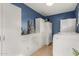 Laundry room with white cabinets and large refrigerator at 313 W Saddle Mountain Rd, Phoenix, AZ 85086