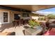 Covered patio with seating, dining, and lush plants at 313 W Saddle Mountain Rd, Phoenix, AZ 85086