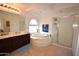 This bathroom features a tub, shower, and double sink at 31689 N Blackfoot Dr, San Tan Valley, AZ 85143