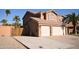 Two-story home with a three-car garage and mature palm trees at 31689 N Blackfoot Dr, San Tan Valley, AZ 85143