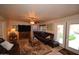 Living room featuring a cozy leather sofa and tile floors at 31689 N Blackfoot Dr, San Tan Valley, AZ 85143