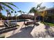 Relaxing pool area with lounge chairs, a swing and lush palm trees for a private, resort-like experience at 31689 N Blackfoot Dr, San Tan Valley, AZ 85143