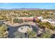 Aerial view of community clubhouse with circular drive, landscaping, and mountain views at 33108 N 72Nd Way, Scottsdale, AZ 85266