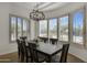 Bright dining room with large windows and elegant chandelier at 33108 N 72Nd Way, Scottsdale, AZ 85266