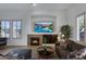 Relaxing living room featuring a cozy fireplace and sectional sofa at 33108 N 72Nd Way, Scottsdale, AZ 85266