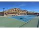 Tennis court with mountain backdrop and seating area at 33108 N 72Nd Way, Scottsdale, AZ 85266