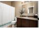 Clean bathroom with granite countertop, updated vanity, and striped shower curtain at 33610 N 26Th Ave, Phoenix, AZ 85085