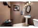 Elegant powder room with pedestal sink and decorative mirror at 33610 N 26Th Ave, Phoenix, AZ 85085