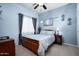 Bright bedroom featuring a wood bed frame, light blue walls, and ample natural light at 33610 N 26Th Ave, Phoenix, AZ 85085