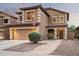 Two-story house with tan exterior, landscaped yard, and a two-car garage at 33610 N 26Th Ave, Phoenix, AZ 85085