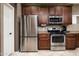 Kitchen area with stainless steel appliances and wood cabinetry at 33610 N 26Th Ave, Phoenix, AZ 85085