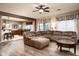 Spacious living room with L-shaped sectional sofa, wood floors, and a view of the kitchen at 33610 N 26Th Ave, Phoenix, AZ 85085