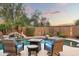 Relaxing poolside patio with wicker chairs, fire pit table, and tranquil water feature at 33610 N 26Th Ave, Phoenix, AZ 85085