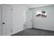 Bright bedroom with grey carpet and an ensuite bathroom at 3426 W Elm St, Phoenix, AZ 85017