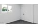 Bedroom with window, closet, and grey carpeting at 3426 W Elm St, Phoenix, AZ 85017