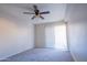 Bright bedroom with ceiling fan and sliding door at 3535 W Tierra Buena Ln # 156, Phoenix, AZ 85053