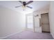 Bright bedroom featuring ceiling fan and mirrored closet doors at 3535 W Tierra Buena Ln # 156, Phoenix, AZ 85053