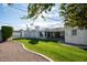 Expansive backyard with a large grassy area and curved gravel border at 3601 N 48Th Way, Phoenix, AZ 85018