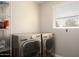 Laundry room with washer, dryer, and shelving unit at 3601 N 48Th Way, Phoenix, AZ 85018