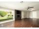 Living room with hardwood floors, fireplace, and backyard view at 3601 N 48Th Way, Phoenix, AZ 85018