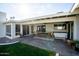 Outdoor patio with seating area, hot tub, and adjacent grassy area at 3601 N 48Th Way, Phoenix, AZ 85018